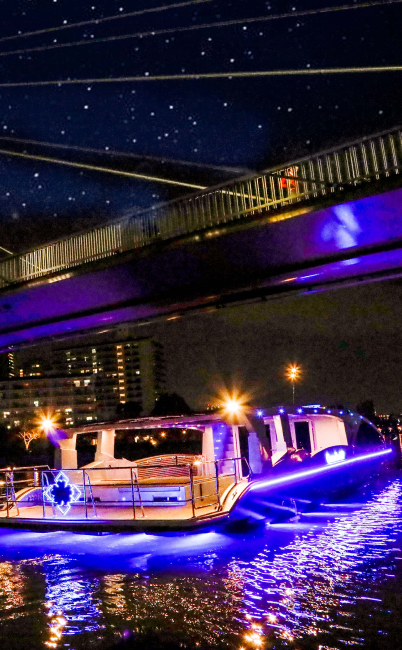 夜の大川をクルーズ船が進む様子